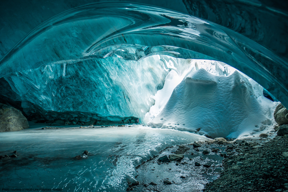 Inside aqua blue ice cave in British Columbia.