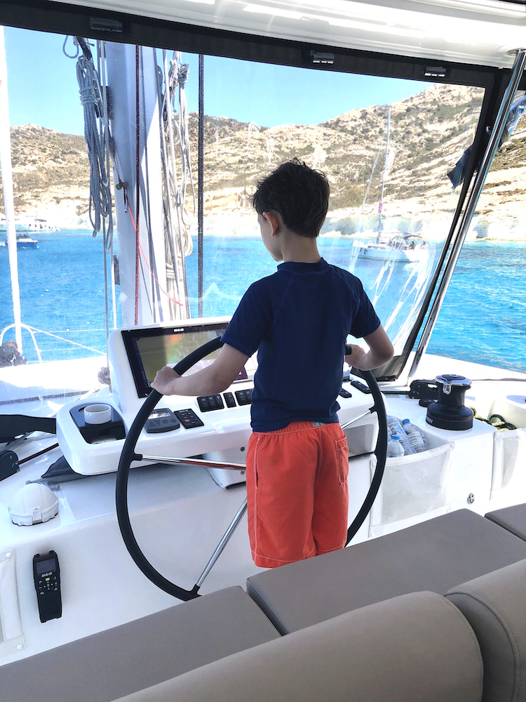 Steering the boat The Ultimate Guide To Boat Charter In Greece Part 1